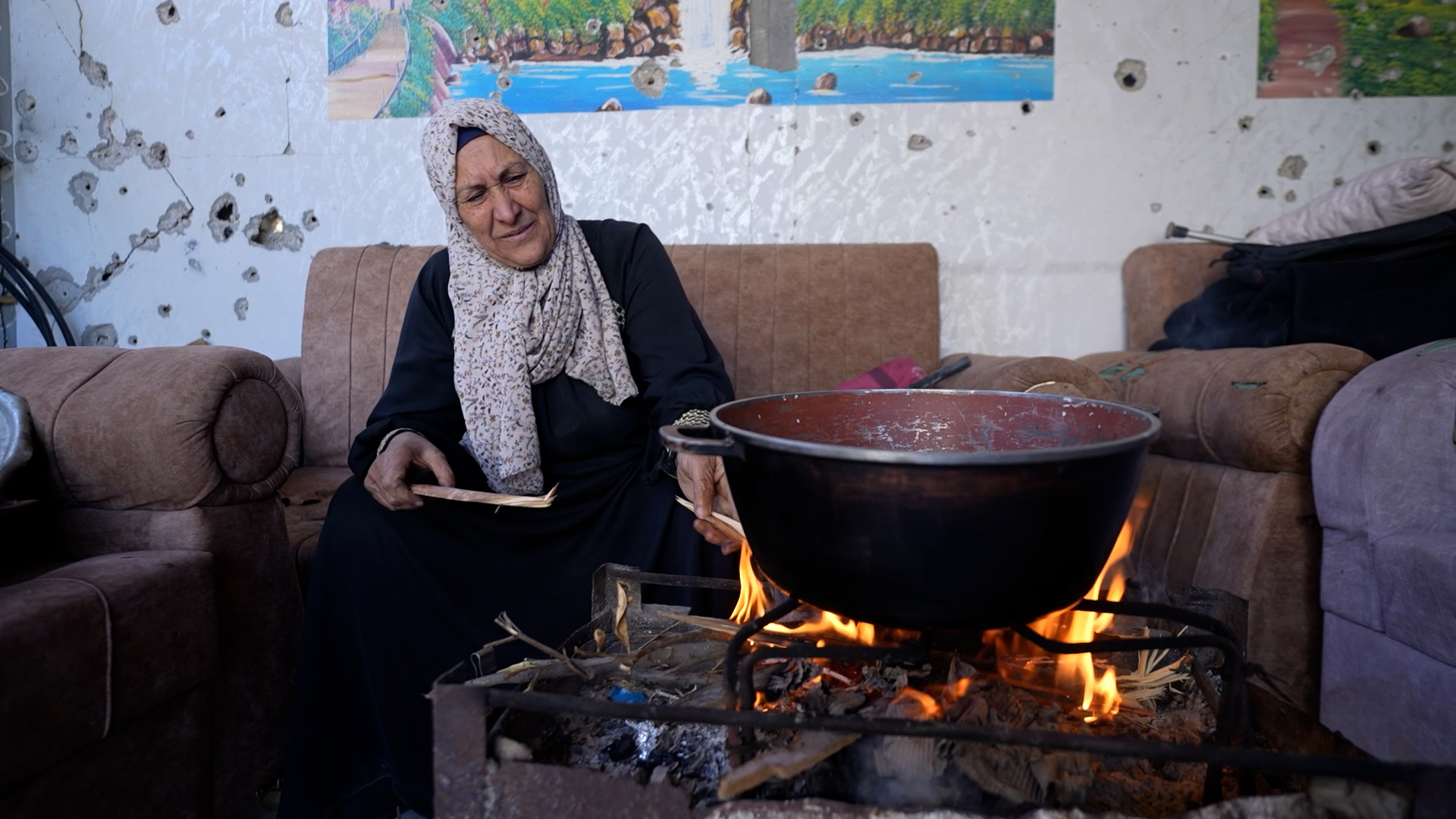 woman sitting on couch before open wood fire